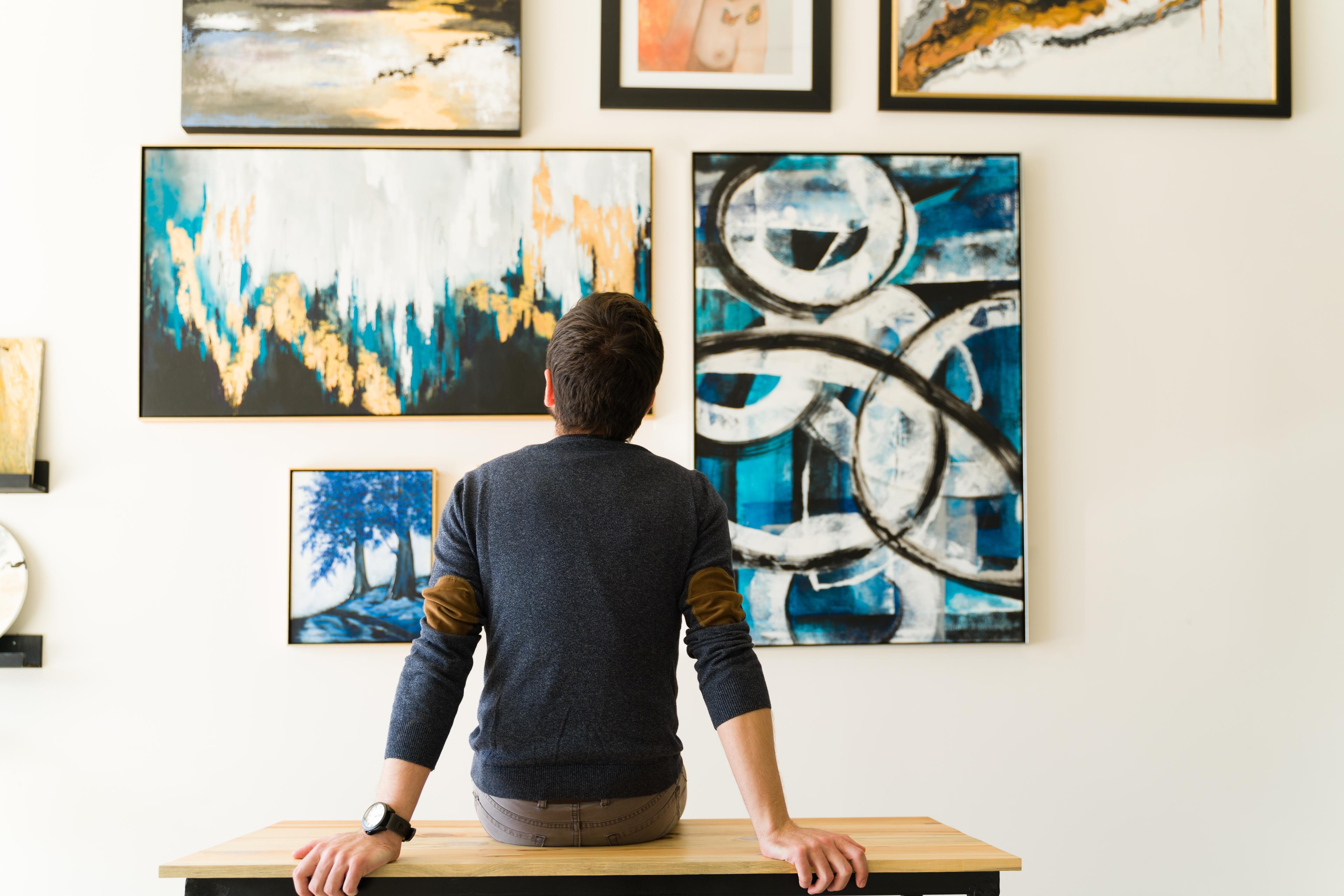 image of a man viewing art in a gallery